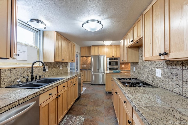 kitchen featuring stainless steel appliances, sink, light brown cabinetry, and decorative backsplash