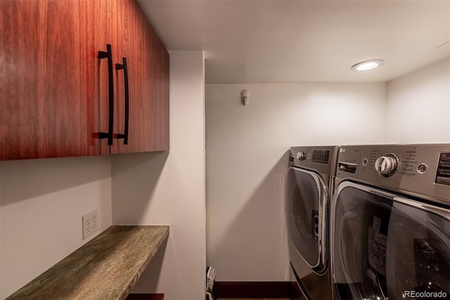 laundry area with cabinets and washing machine and dryer