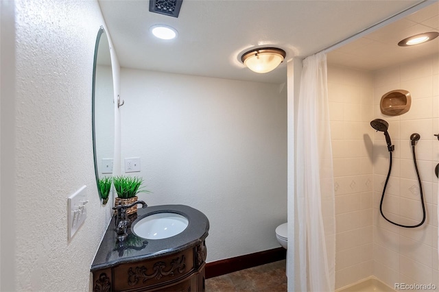 bathroom featuring vanity, a shower with shower curtain, and toilet