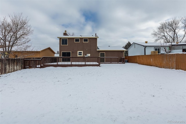 view of snow covered rear of property