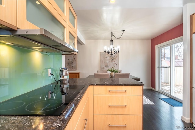 kitchen with light brown cabinetry, glass insert cabinets, and black electric cooktop