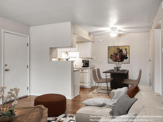 8335 Fairmount Dr Unit 9-206, Denver, CO 80247 - living area with a textured ceiling, wood finished floors, and a ceiling fan