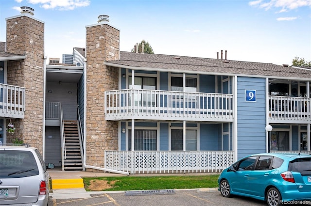 8335 Fairmount Dr Unit 9-206, Denver, CO 80247 - view of property featuring stairs and uncovered parking