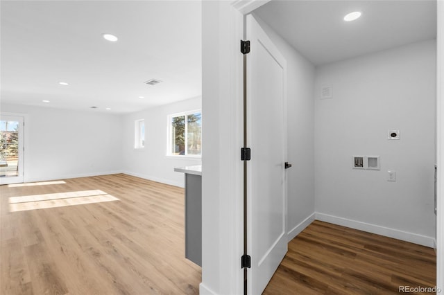 washroom with electric dryer hookup, hardwood / wood-style flooring, and hookup for a washing machine