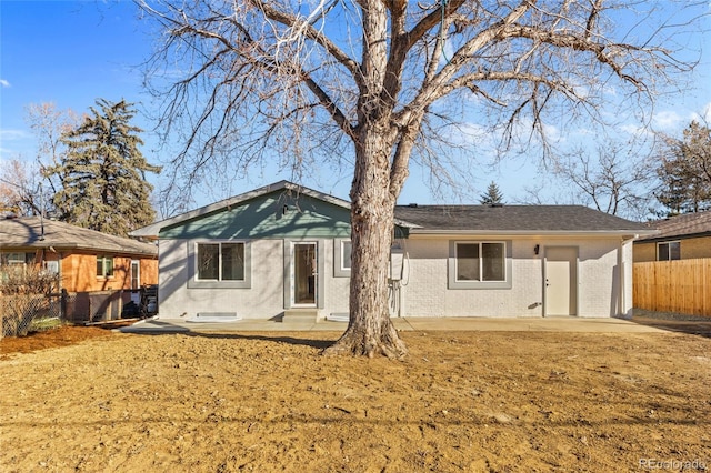 rear view of house with a lawn and a patio