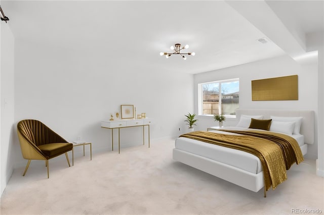 bedroom featuring light carpet and a chandelier