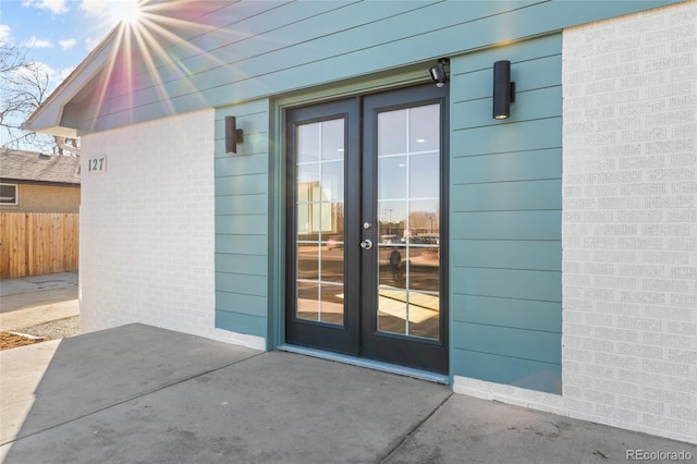 view of exterior entry featuring a patio and french doors