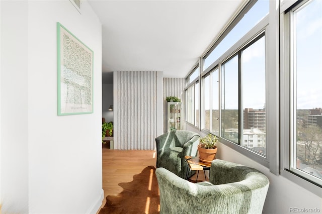 sunroom featuring visible vents and wood finished floors