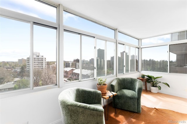 sunroom with baseboards and a city view