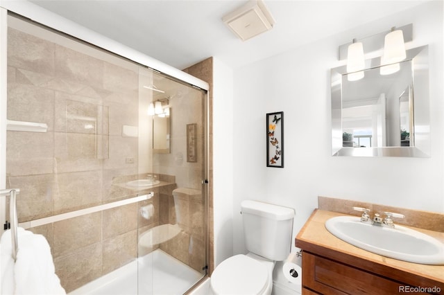 full bath featuring vanity, a stall shower, and toilet