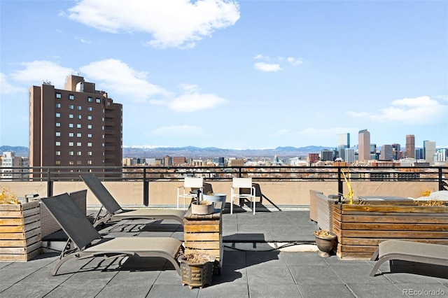 view of patio with a city view and a mountain view