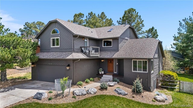 view of front facade featuring concrete driveway, fence, roof with shingles, and a garage
