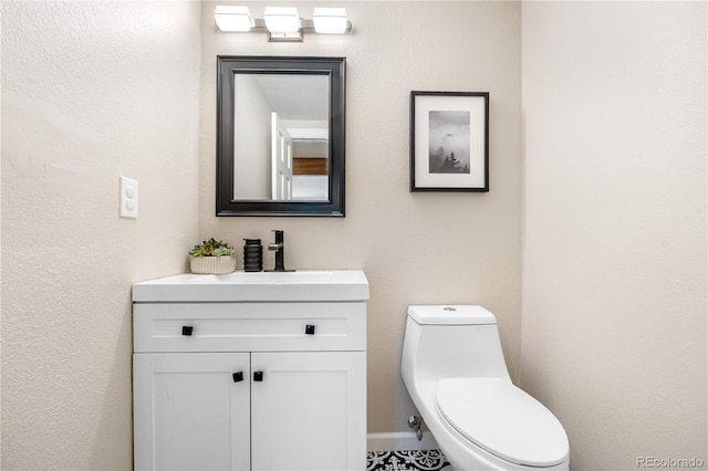 bathroom featuring vanity and toilet