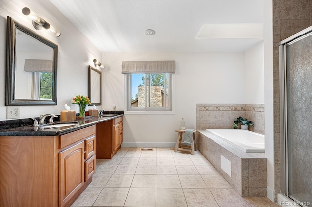 bathroom featuring double vanity, a garden tub, an enclosed shower, a sink, and tile patterned floors