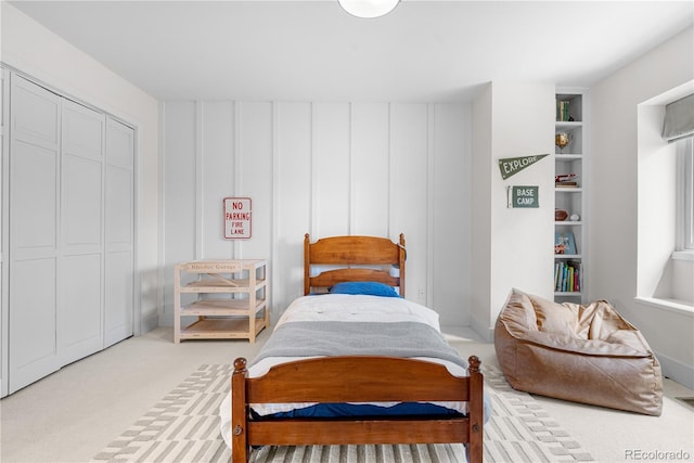 bedroom featuring a closet and light carpet
