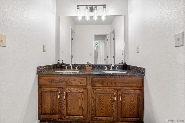 bathroom featuring double vanity and a sink