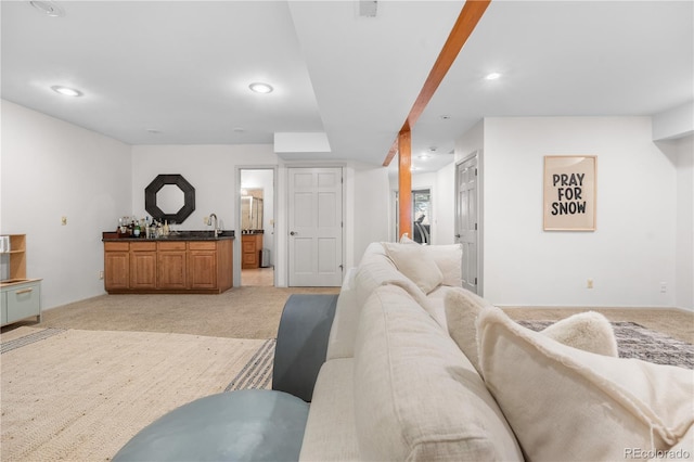 living room with light carpet, recessed lighting, and wet bar