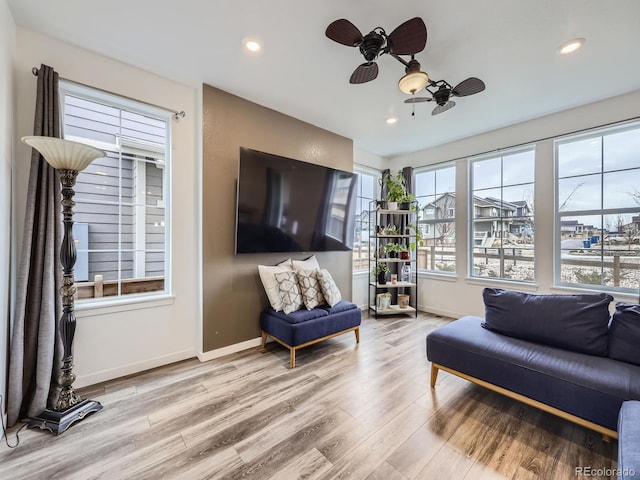 sitting room with light hardwood / wood-style floors and ceiling fan