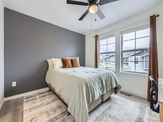 bedroom with light wood-type flooring and ceiling fan