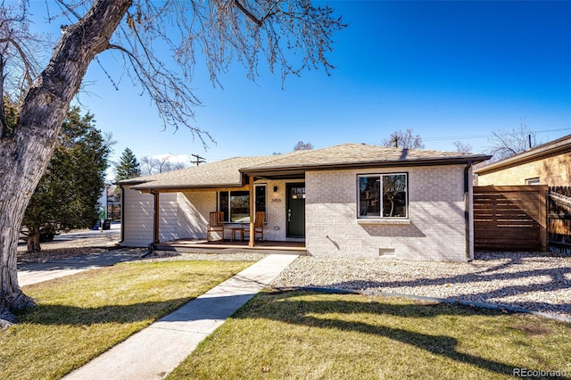 view of front facade featuring a porch, crawl space, fence, a front lawn, and brick siding