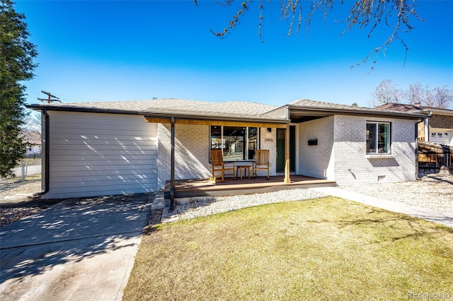 single story home featuring brick siding, a porch, crawl space, fence, and a front lawn