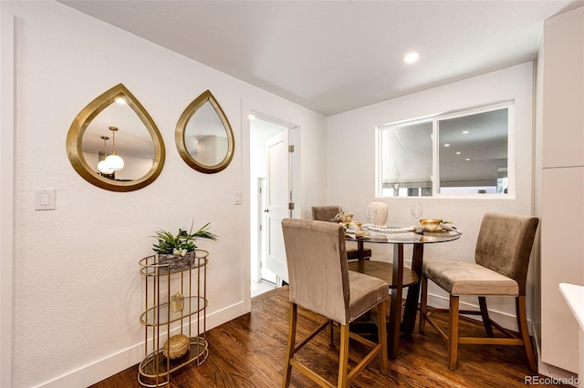 dining room with dark wood-style floors and baseboards