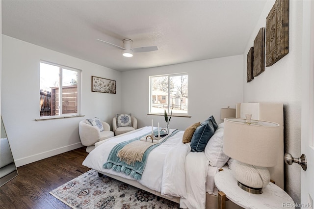 bedroom with wood finished floors, a ceiling fan, and baseboards