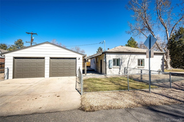 ranch-style home with a fenced front yard, an outbuilding, and a garage