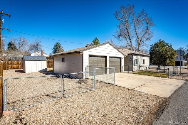 view of front of house with an outbuilding, a gate, a garage, and fence