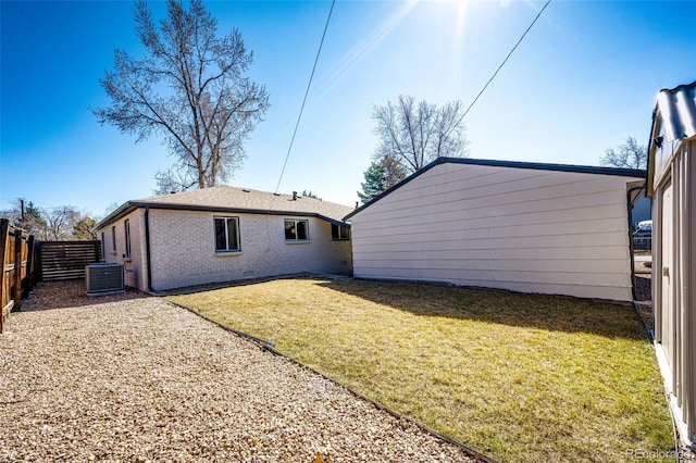 back of property featuring a fenced backyard, crawl space, a yard, central air condition unit, and brick siding