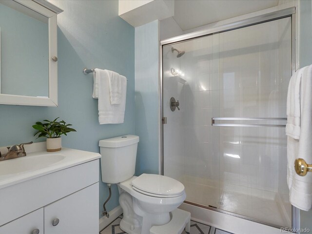 6869 Quay St, Arvada, CO 80003 - full bath with toilet, a stall shower, vanity, and tile patterned floors