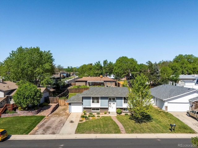6869 Quay St, Arvada, CO 80003 - split foyer home featuring concrete driveway, a residential view, and a shingled roof