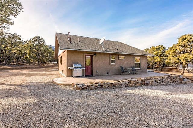 830 High Peaks Ranch Rd, Coaldale, CO 81222 - rear view of house featuring a patio, stucco siding, and roof with shingles