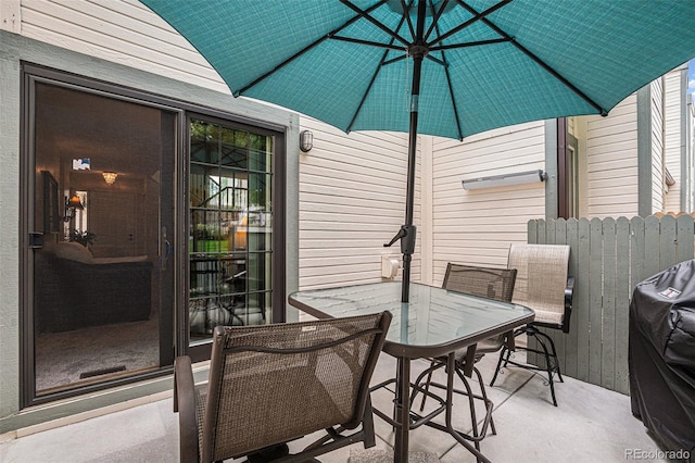 view of patio with outdoor dining area and fence