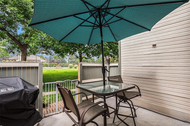 view of patio with grilling area and outdoor dining space