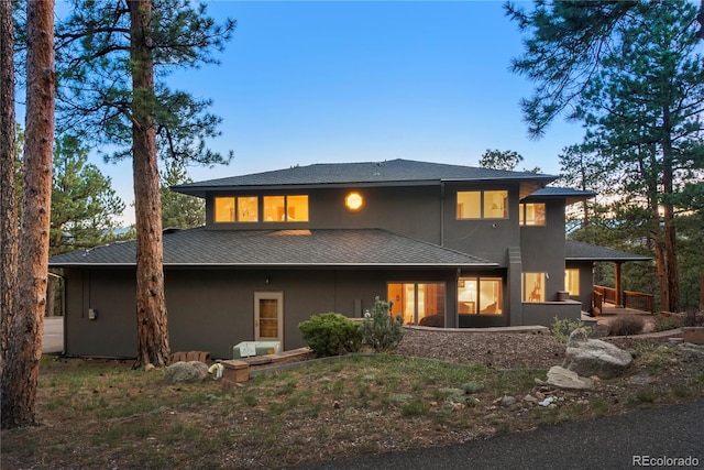 28890 Pinewood Vista Dr, Evergreen, CO 80439 - rear view of property with a shingled roof and stucco siding