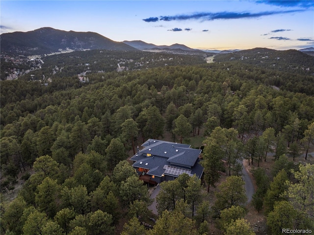 28890 Pinewood Vista Dr, Evergreen, CO 80439 - aerial view at dusk featuring a mountain view and a wooded view