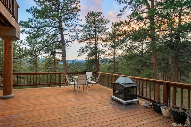 28890 Pinewood Vista Dr, Evergreen, CO 80439 - deck featuring a mountain view and outdoor dining area