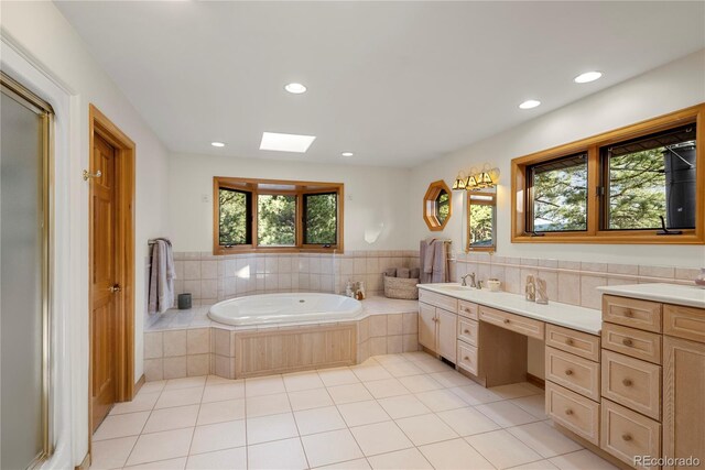 28890 Pinewood Vista Dr, Evergreen, CO 80439 - full bath with vanity, tile patterned flooring, a garden tub, and recessed lighting