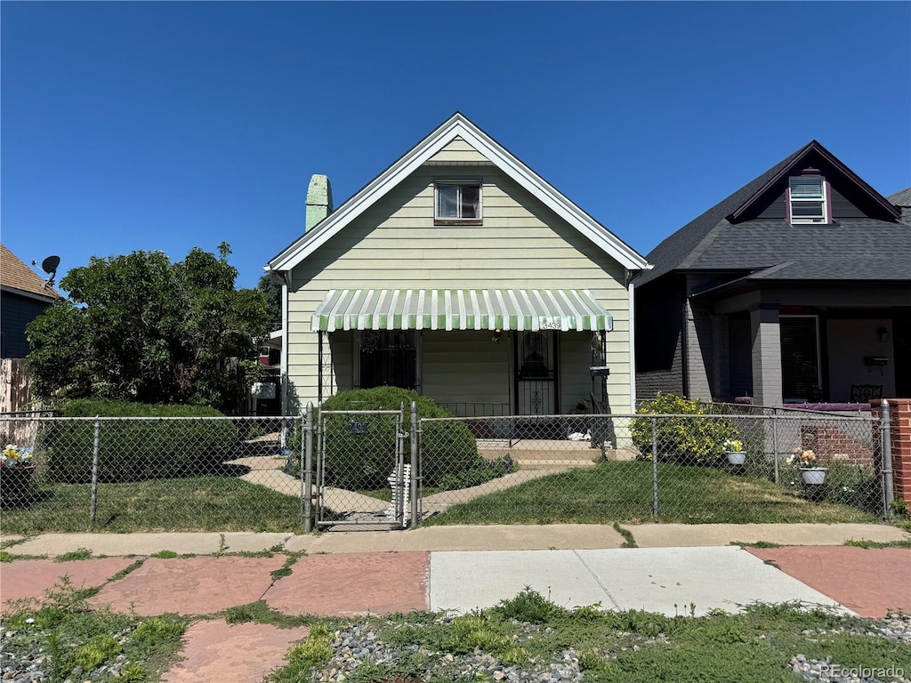 3439 N Lafayette St, Denver, CO 80205 - view of front of property with a fenced front yard, a gate, and a chimney
