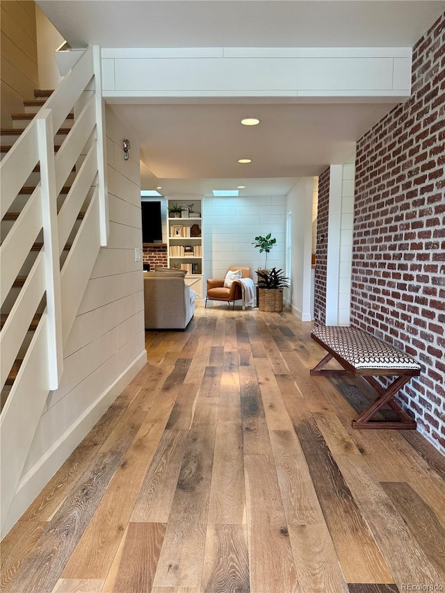 8503 E Jamison Ave, Centennial, CO 80112 - hall with hardwood / wood-style flooring, brick wall, and stairs