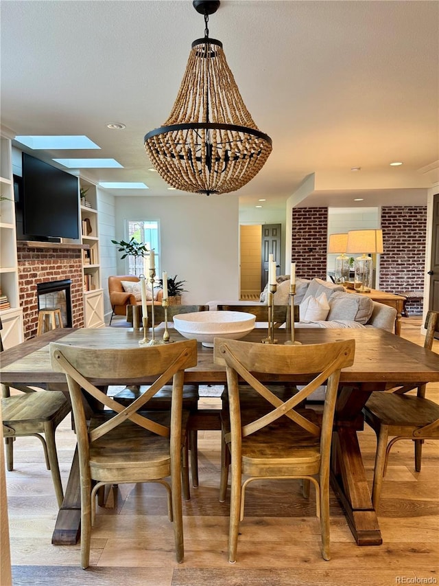8503 E Jamison Ave, Centennial, CO 80112 - dining room featuring a brick fireplace and light wood-style flooring