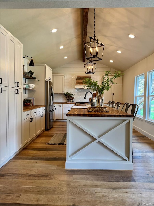 8503 E Jamison Ave, Centennial, CO 80112 - kitchen featuring wooden counters, open shelves, a sink, freestanding refrigerator, and vaulted ceiling with beams