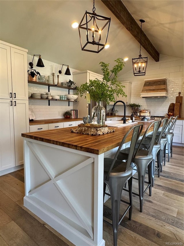 8503 E Jamison Ave, Centennial, CO 80112 - bar featuring a sink, custom range hood, dark wood-style floors, and a notable chandelier