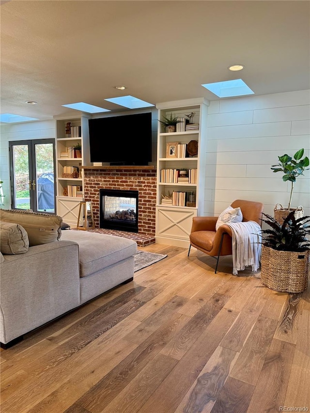 8503 E Jamison Ave, Centennial, CO 80112 - living area with a fireplace, hardwood / wood-style floors, and a skylight