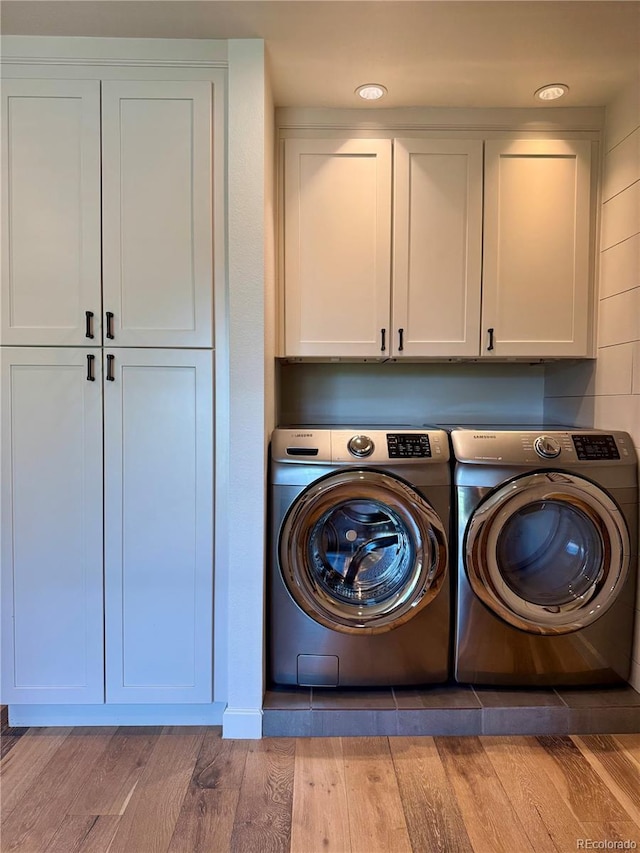 8503 E Jamison Ave, Centennial, CO 80112 - laundry room with light wood-style floors, independent washer and dryer, and cabinet space