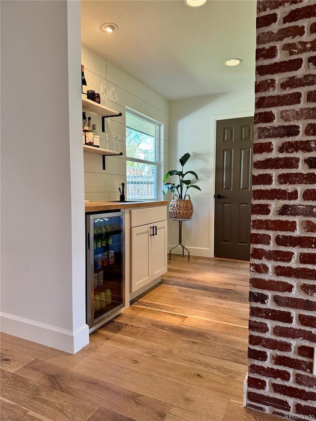 8503 E Jamison Ave, Centennial, CO 80112 - bar featuring light wood-style floors, indoor wet bar, recessed lighting, baseboards, and wine cooler