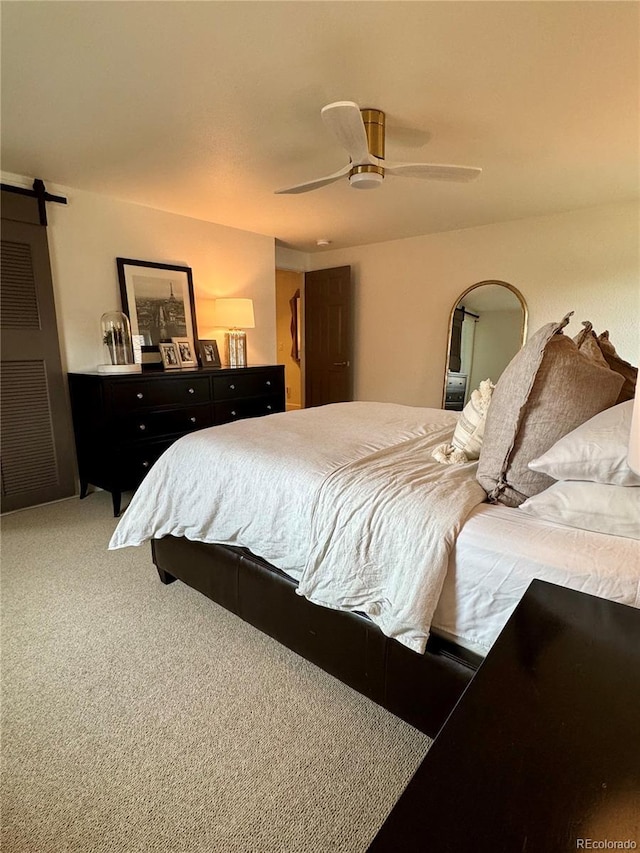 8503 E Jamison Ave, Centennial, CO 80112 - carpeted bedroom with a ceiling fan and a barn door