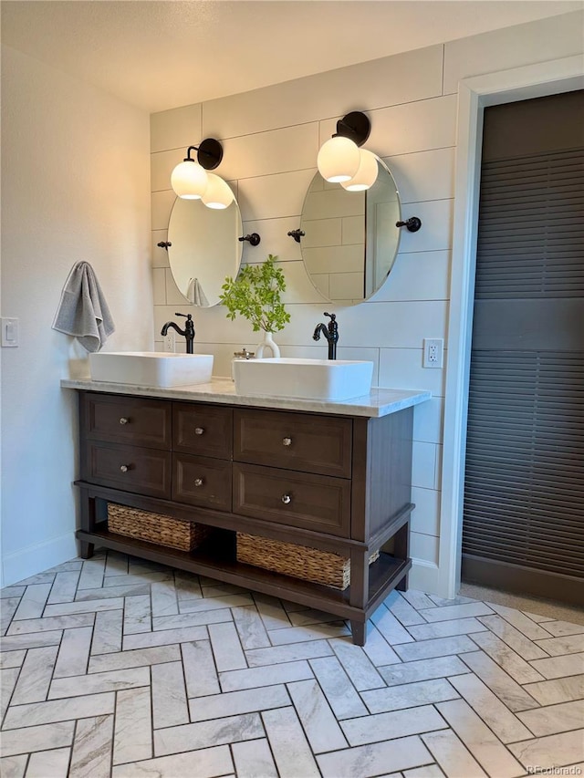 8503 E Jamison Ave, Centennial, CO 80112 - bathroom with baseboards, a sink, and double vanity