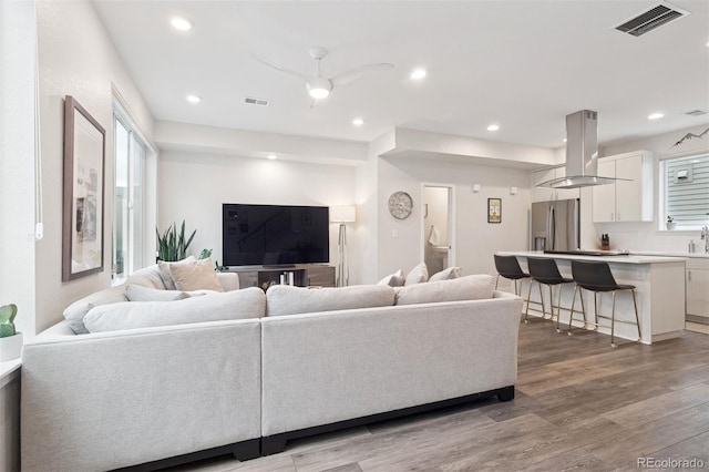 1284 Quitman St, Denver, CO 80204 - living area featuring wood finished floors, a ceiling fan, plenty of natural light, and recessed lighting